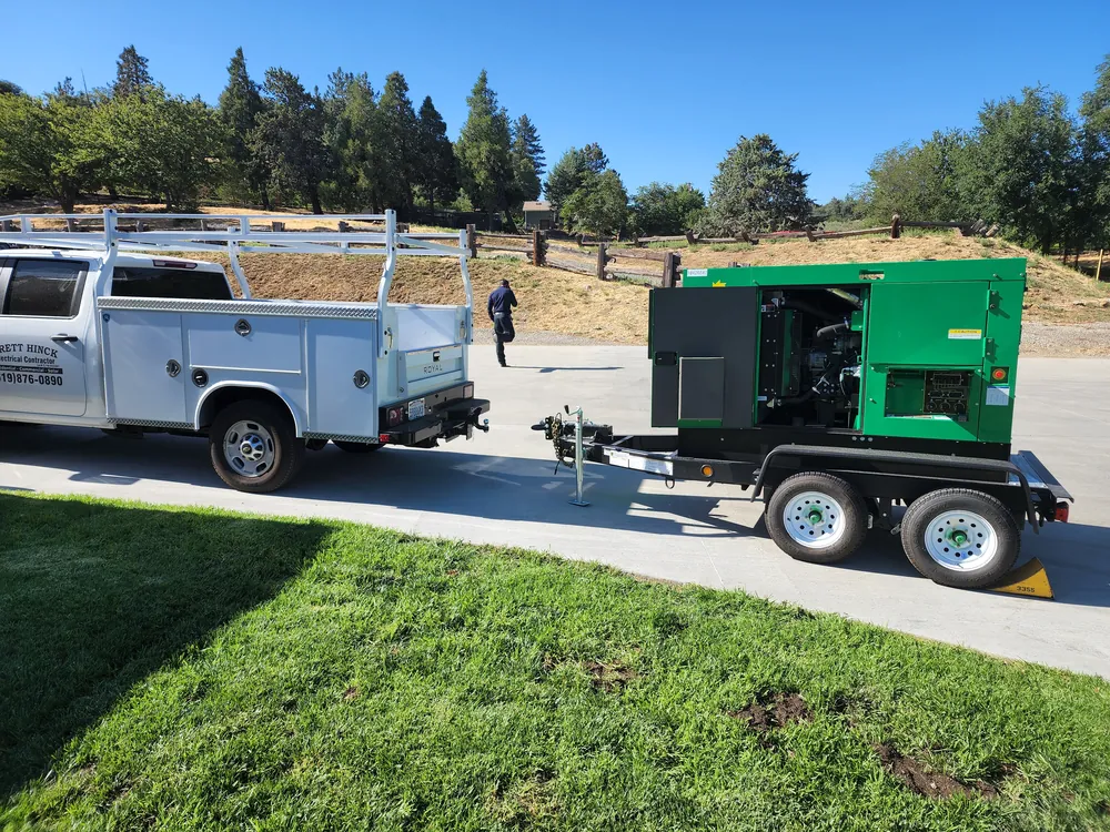 Brett Hinck Electrical service truck towing a generator to a jobsite