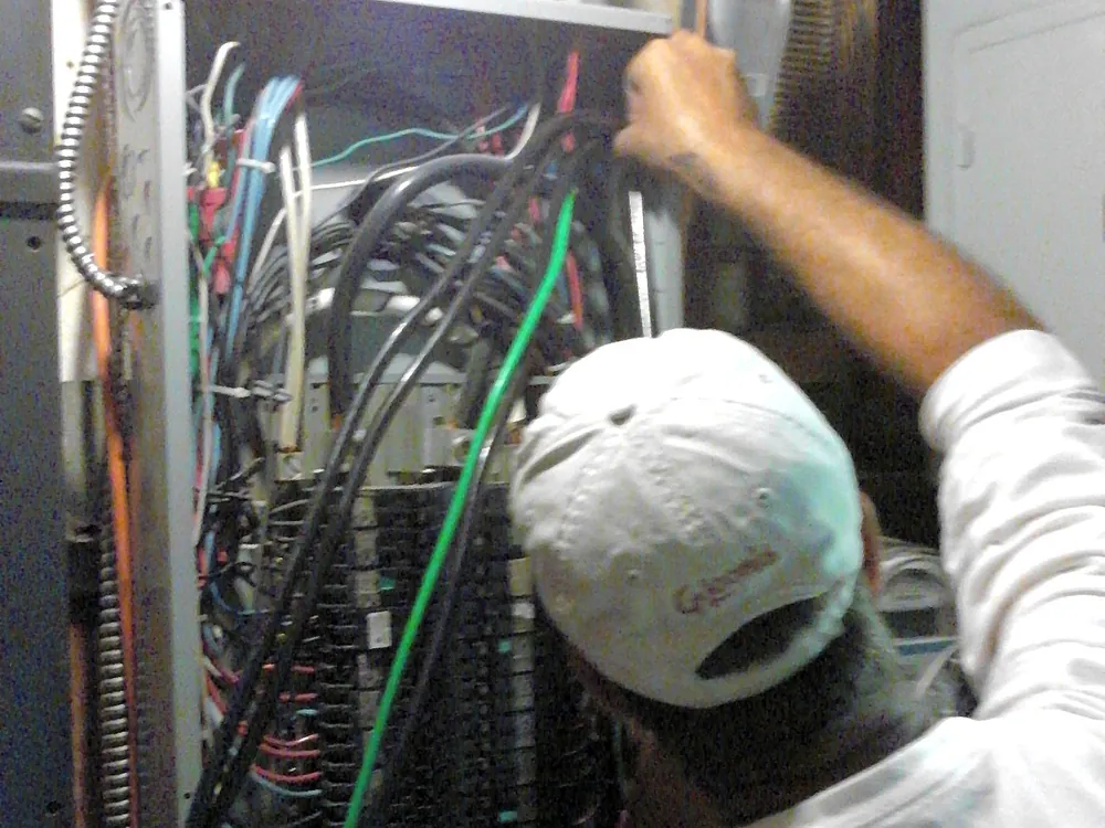 Electrician wiring a commercial panel, Brett Hinck Electrical