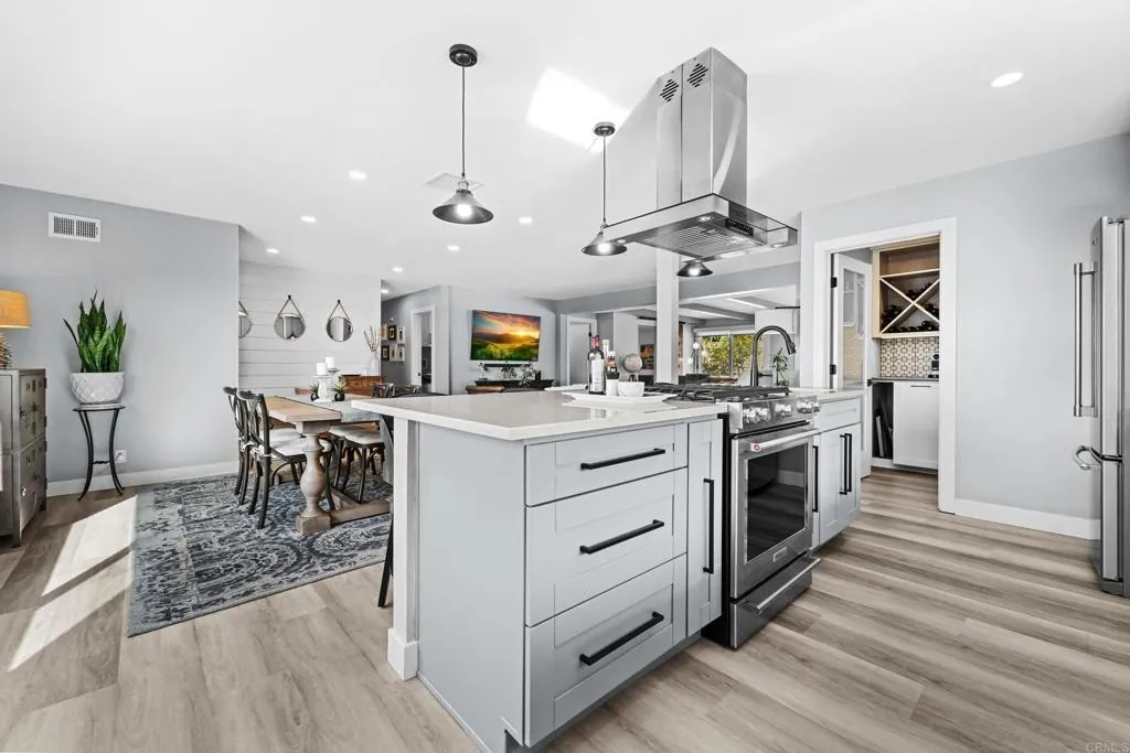 Gray shaker kitchen with island seating by Merribuild
