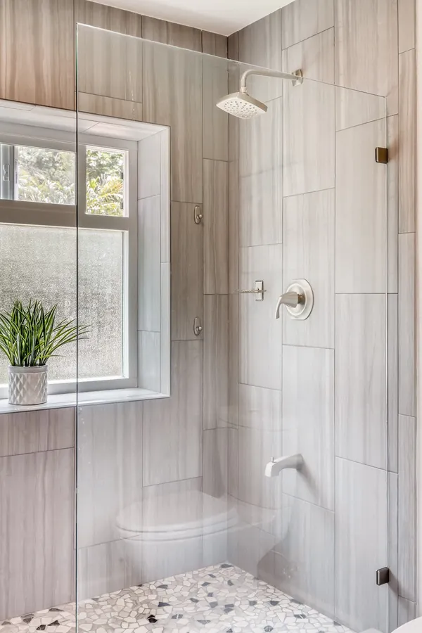 Tiled walk-in shower by Merribuild