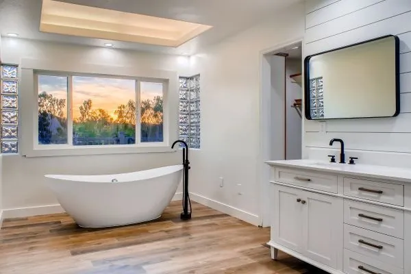 Bathroom remodel with freestanding soaking tub by Merribuild