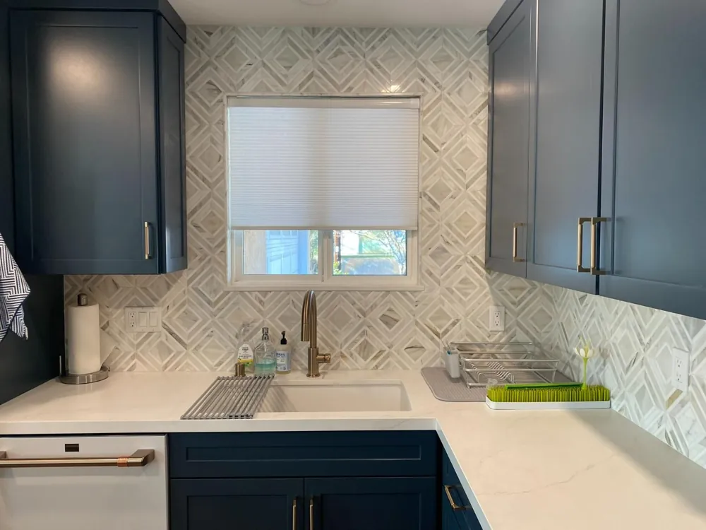 Navy shaker cabinets with patterned backsplash by RCS Pro Build