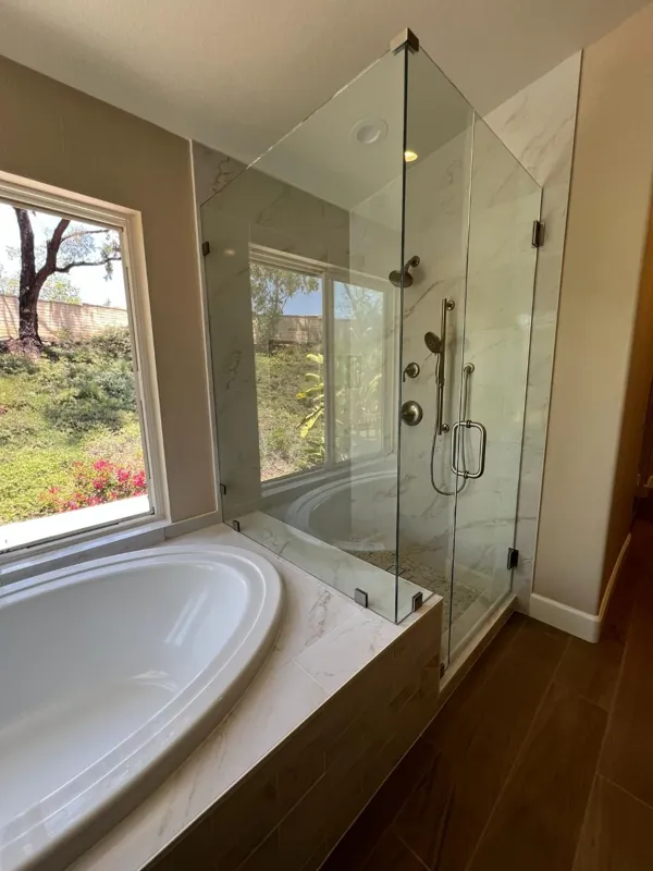 Bathroom remodel with glass shower and soaking tub by RCS Pro Build